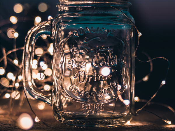 A glass bottle with fairy lights